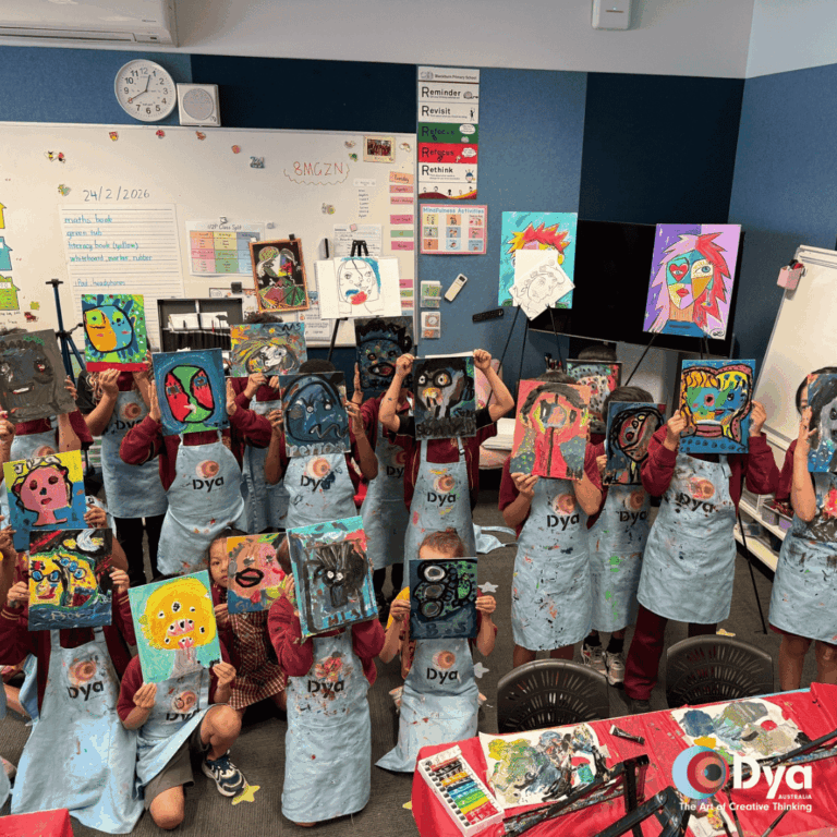 Blackburn Primary School students holding Picasso self portrait artworks during DYA Australia creative art workshop