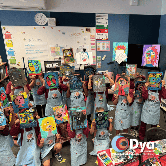 Blackburn Primary School students holding Picasso self portrait artworks during DYA Australia creative art workshop