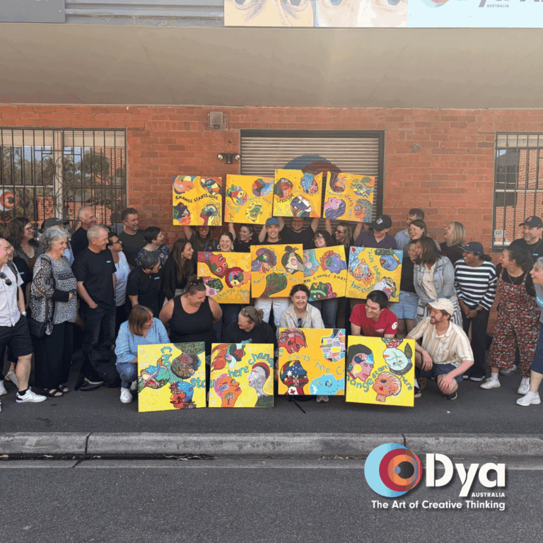 Tearfund Australia team holding their collaborative mural portrait during a creative team building workshop in Melbourne