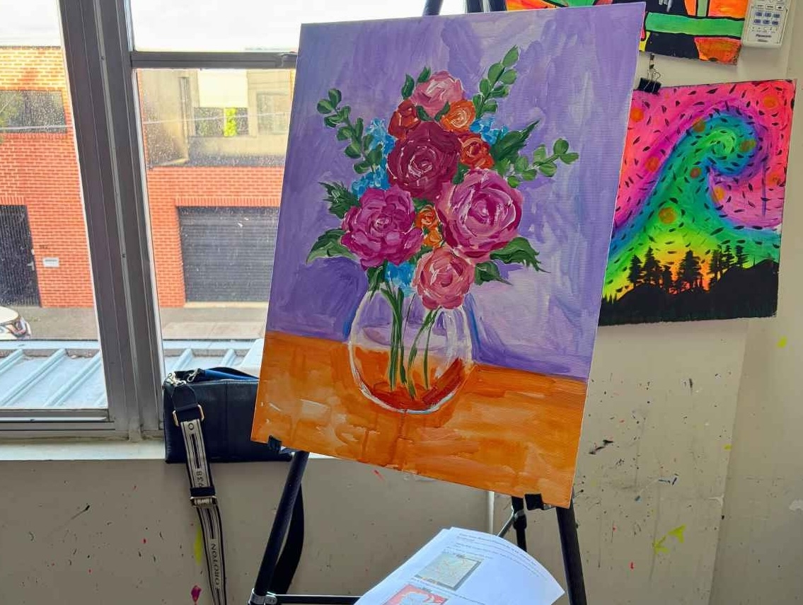 Finished floral painting on an easel in the studio